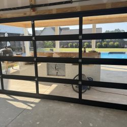 Best Door Co. installer preparing garage door hardware during service call Florence AL